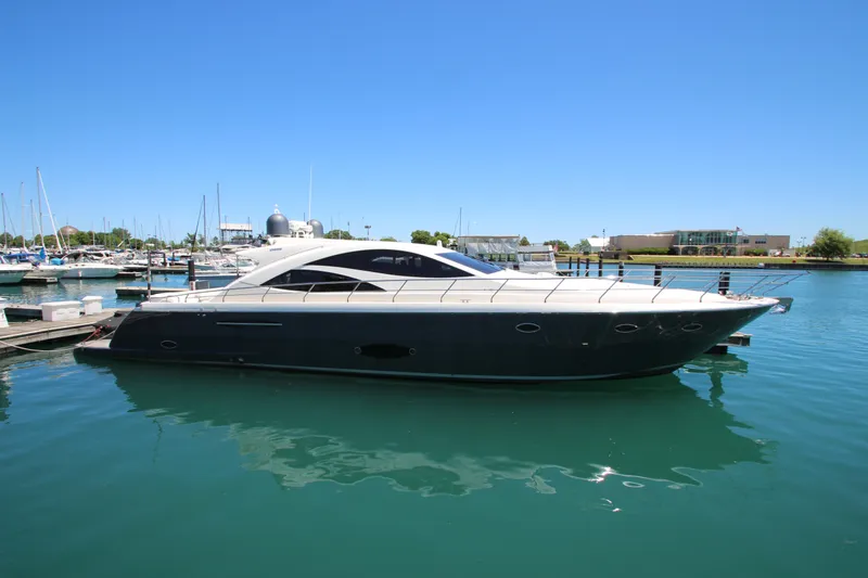 Slide: The Image of Luxury 2007 Uniesse 70 Sport yacht docked in marina under clear blue sky. - 4