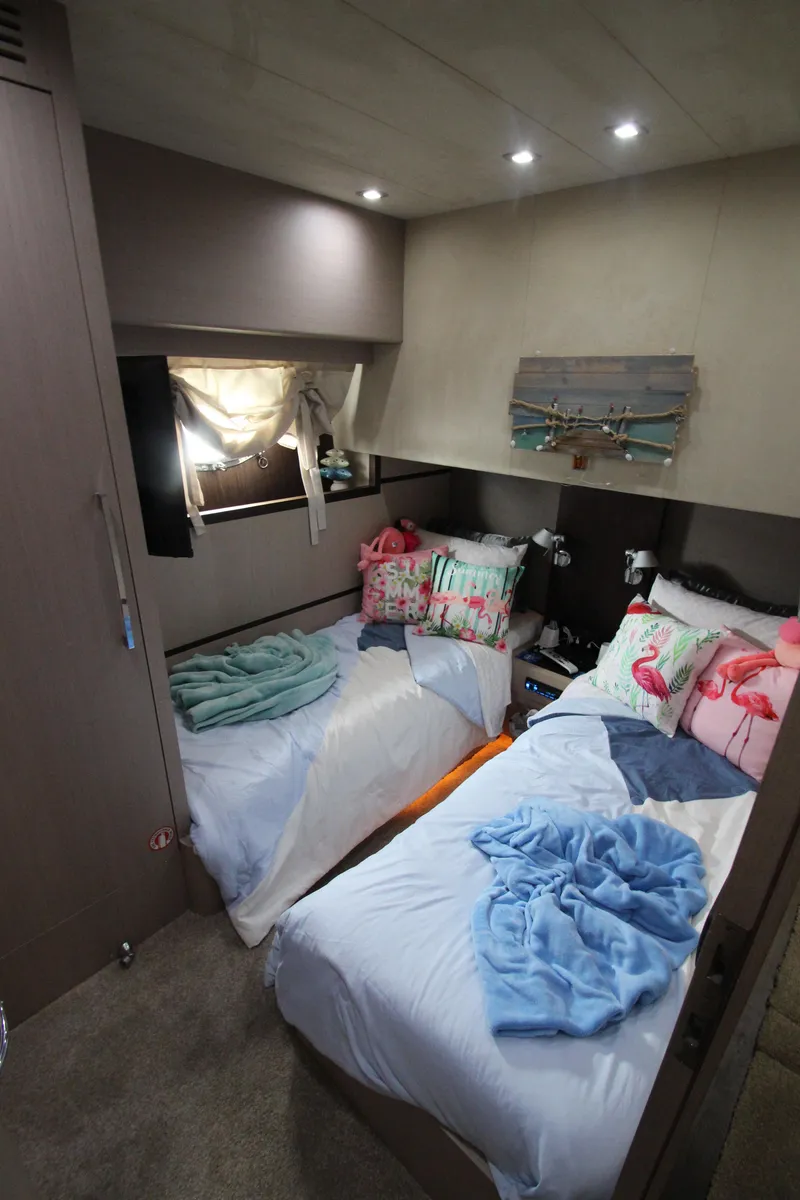 Slide: The Image of Cozy twin bedroom in 2007 Uniesse 70 Sport yacht with colorful pillows and soft lighting. - 41