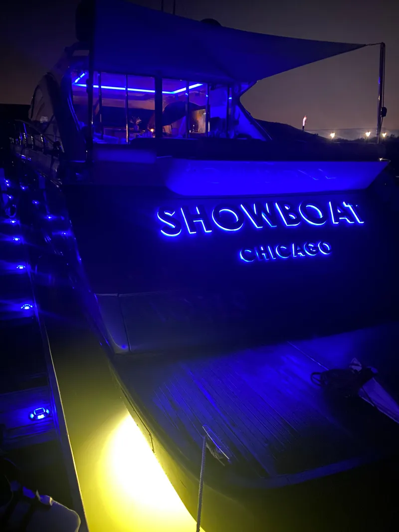 Slide: The Image of Uniesse 70 Sport 2007 yacht with blue neon lights, "Showboat Chicago" displayed. - 6