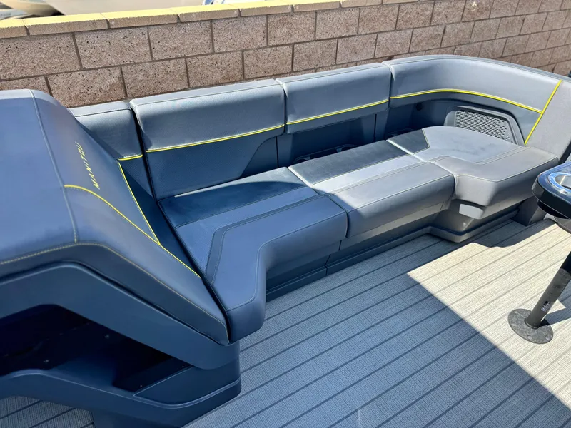 Slide: The Image of 2024 Manitou Explore 24 Navigator boat seating with sleek design and modern upholstery. - 10