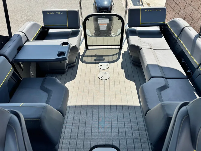Slide: The Image of 2024 Manitou Explore 24 Navigator interior with spacious seating and table, showcasing luxury design. - 13