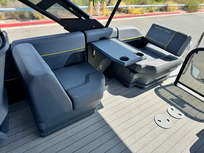 Slide: The Image of 2024 Manitou Explore 24 Navigator boat interior with seating and table. - 14