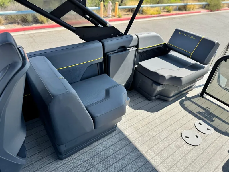 Slide: The Image of 2024 Manitou Explore 24 Navigator boat interior with modern seating and sleek design. - 15