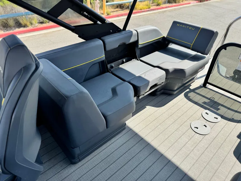 Slide: The Image of 2024 Manitou Explore 24 Navigator boat interior with sleek seating design. - 16