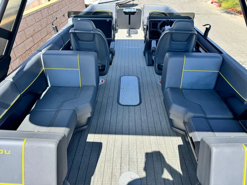 Slide: The Image of 2024 Manitou Explore 24 Navigator boat interior with gray seating and yellow accents. - 20