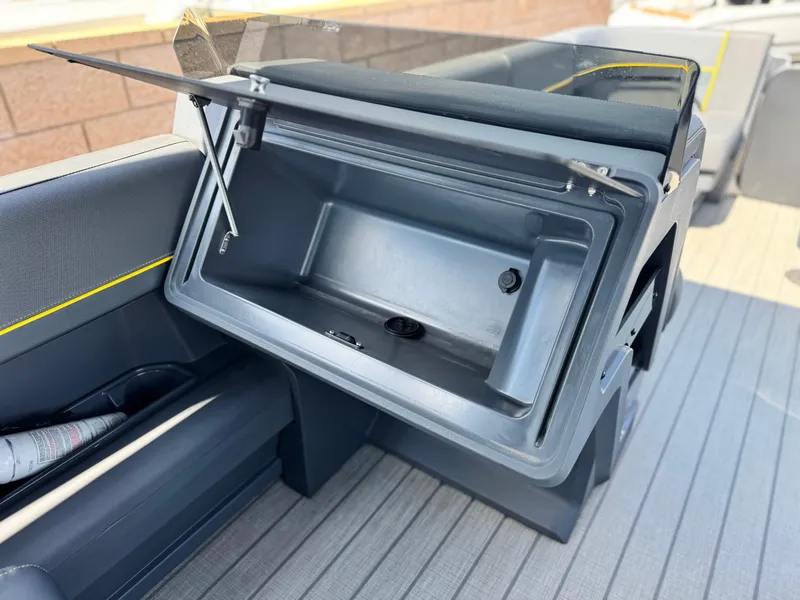 Slide: The Image of Open storage compartment on 2024 Manitou Explore 24 Navigator boat. - 22