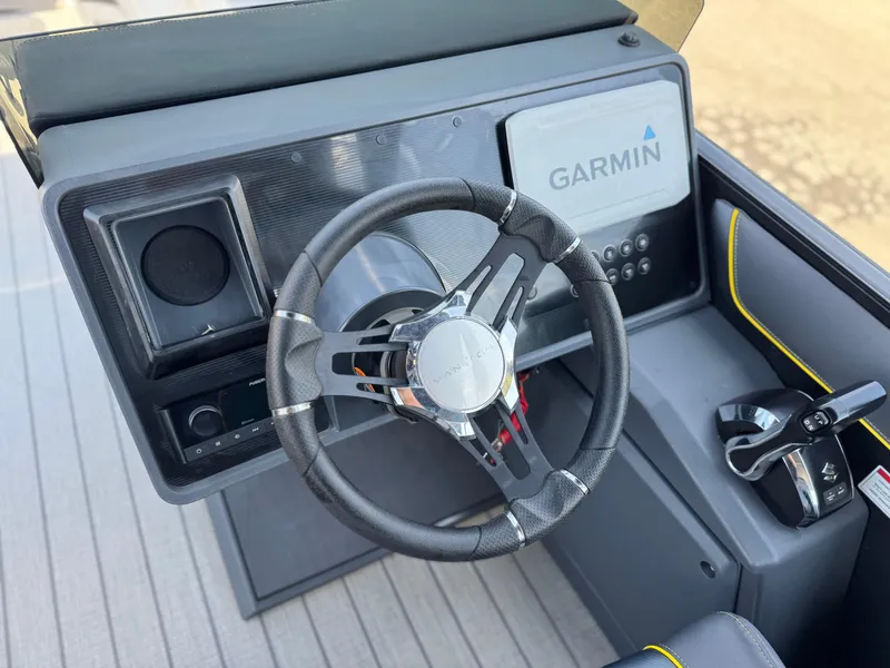 Slide: The Image of 2024 Manitou Explore 24 Navigator dashboard with Garmin display and steering wheel. - 26