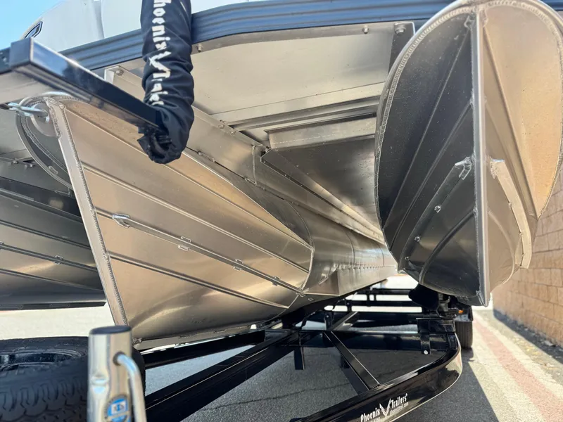 Slide: The Image of Underneath view of 2024 Manitou Explore 24 Navigator pontoon boat on trailer. - 4