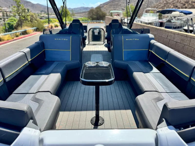 Slide: The Image of 2024 Manitou Explore 24 Navigator boat interior with spacious seating and sleek design. - 8