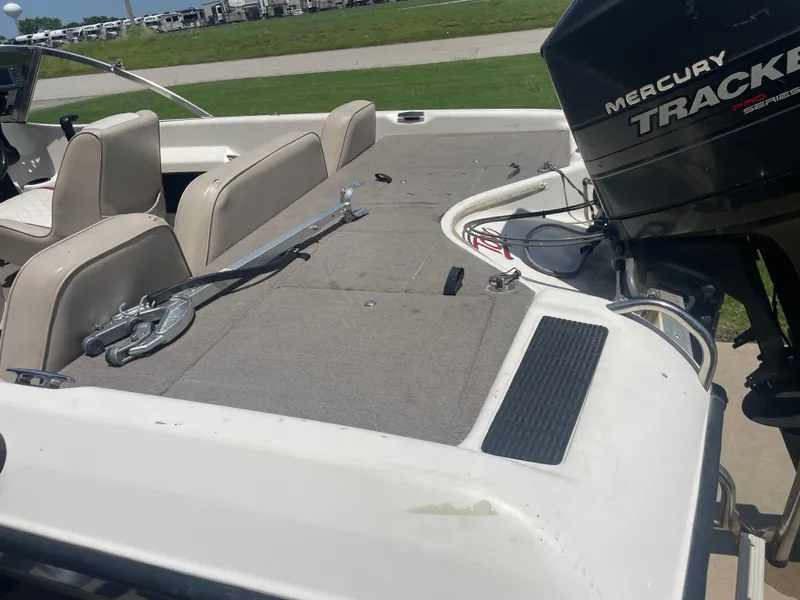 Slide: The Image of 1995 Nitro 185SF boat interior with Mercury Tracker engine, featuring seating and deck area. - 10