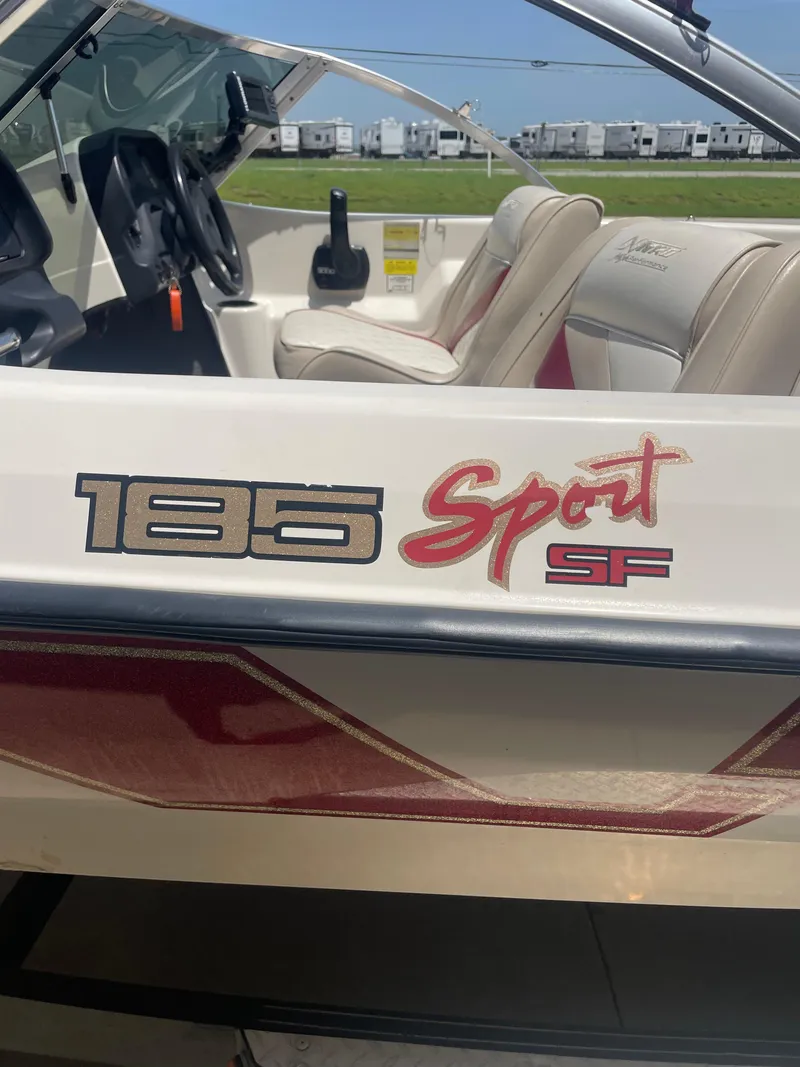 Slide: The Image of 1995 Nitro 185SF Sport boat interior with steering wheel and seats. - 11