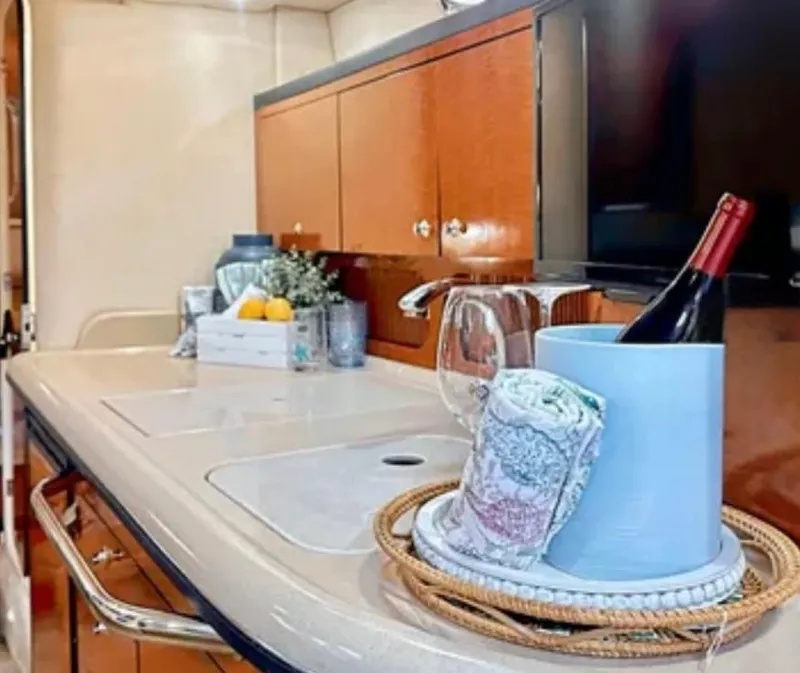 Slide: The Image of 2004 Sea Ray 340 Sundancer helm with luxurious seating and modern navigation controls. - 10