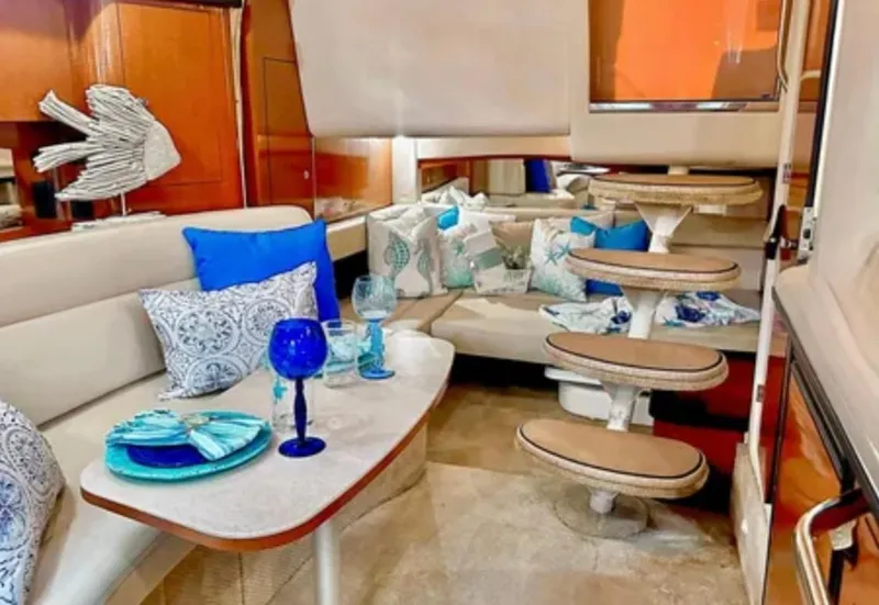 Slide: The Image of Luxurious 2004 Sea Ray 340 Sundancer yacht interior with plush seating and elegant table setting. - 15