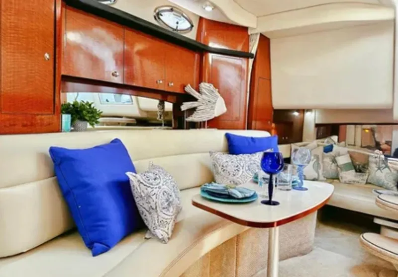 Slide: The Image of 2004 Sea Ray 340 Sundancer interior with kitchenette, bed, and seating area. - 16