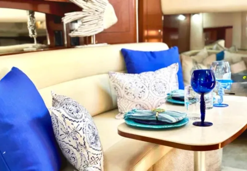 Slide: The Image of Luxurious interior of 2004 Sea Ray 340 Sundancer with cozy seating and elegant dining setup. - 17