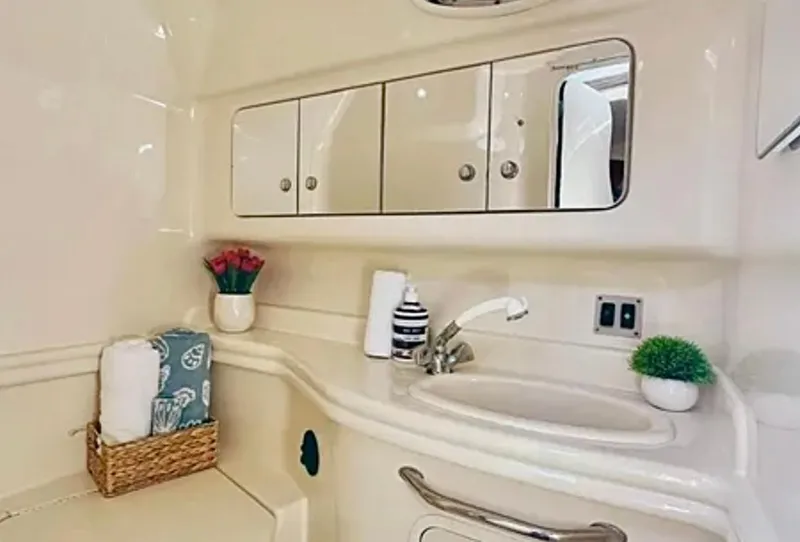 Slide: The Image of Interior of 2004 Sea Ray 340 Sundancer yacht with kitchenette and cozy sleeping area. - 18