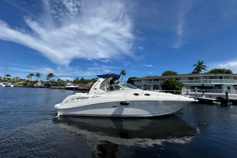 Slide: The Image of Luxurious interior of 2004 Sea Ray 340 Sundancer with elegant dining setup and blue accents. - 28