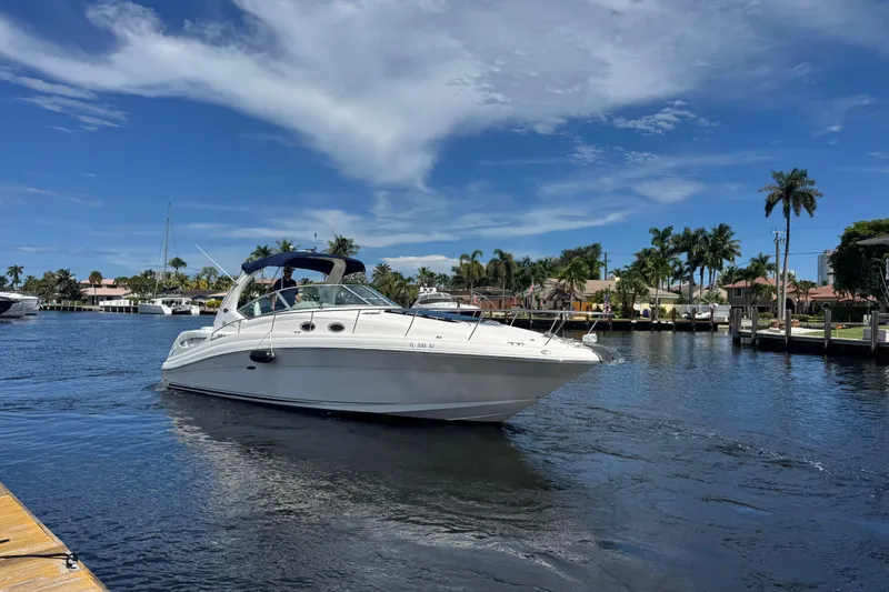 Slide: The Image of Interior of 2004 Sea Ray 340 Sundancer with cozy seating and nautical decor. - 30