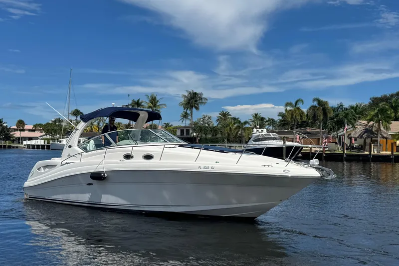 Slide: The Image of Interior of 2004 Sea Ray 340 Sundancer with beige seating and wooden steps. - 32