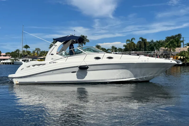Slide: The Image of 2004 Sea Ray 340 Sundancer bathroom with toilet, sink, and storage cabinets. - 33