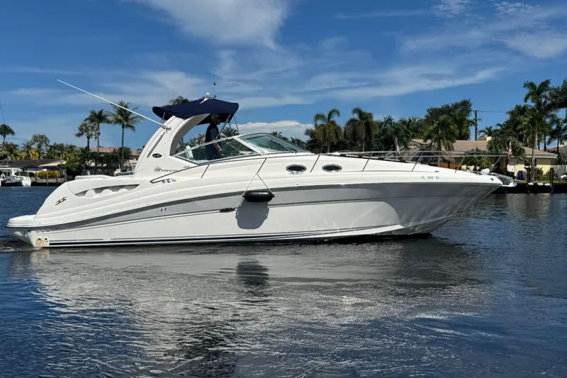 Slide: The Image of Control panel of a 2004 Sea Ray 340 Sundancer boat, featuring various switches and displays. - 35