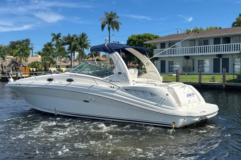 Slide: The Image of 2004 Sea Ray 340 Sundancer yacht cruising on a sunny day near waterfront homes. - 39