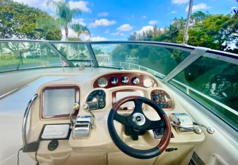 Slide: The Image of 2004 Sea Ray 340 Sundancer boat with white seating and wooden deck. - 8