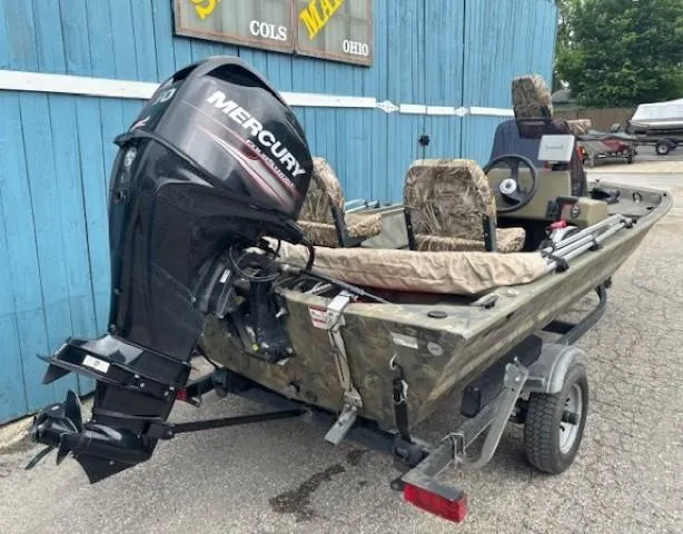 Slide: The Image of 2018 Tracker Grizzly 1648 SC boat with Mercury outboard motor on trailer. - 3