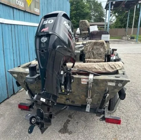 Slide: The Image of 2018 Tracker Grizzly 1648 SC boat with Mercury 50 HP outboard motor, parked outdoors. - 4