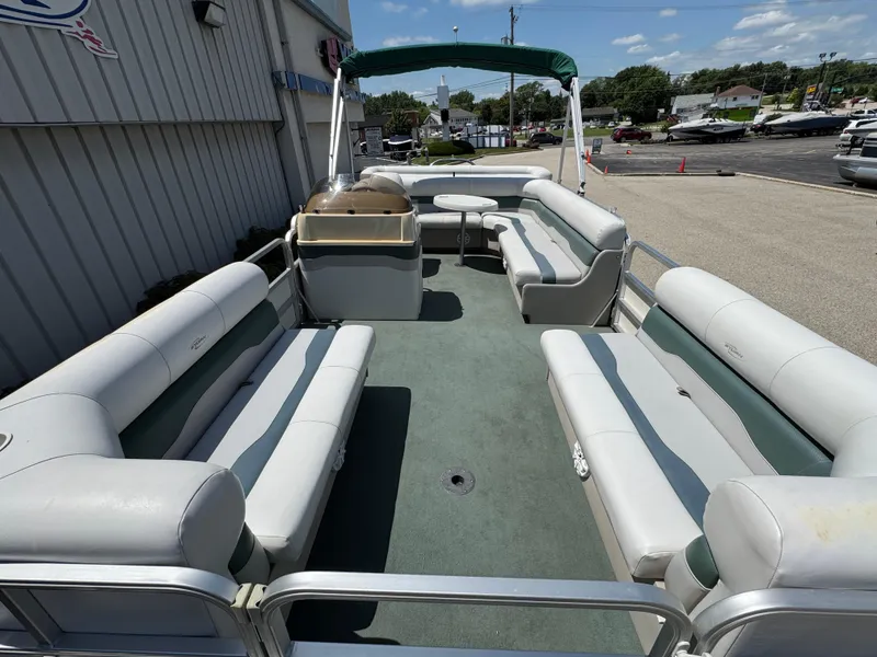 Slide: The Image of 2003 Sylvan 820 Mirage Cruise pontoon boat with spacious seating and canopy, docked outdoors. - 10