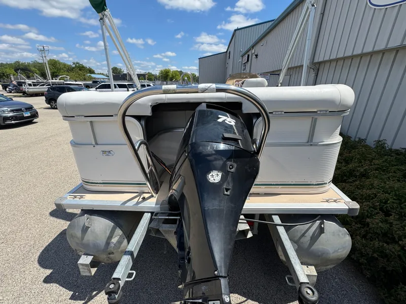 Slide: The Image of 2003 Sylvan 820 Mirage Cruise pontoon boat with outboard motor, parked outdoors. - 11