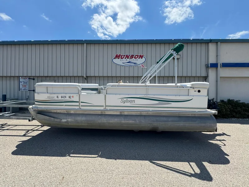 Slide: The Image of 2003 Sylvan 820 Mirage Cruise pontoon boat parked outside a marine shop. - 3