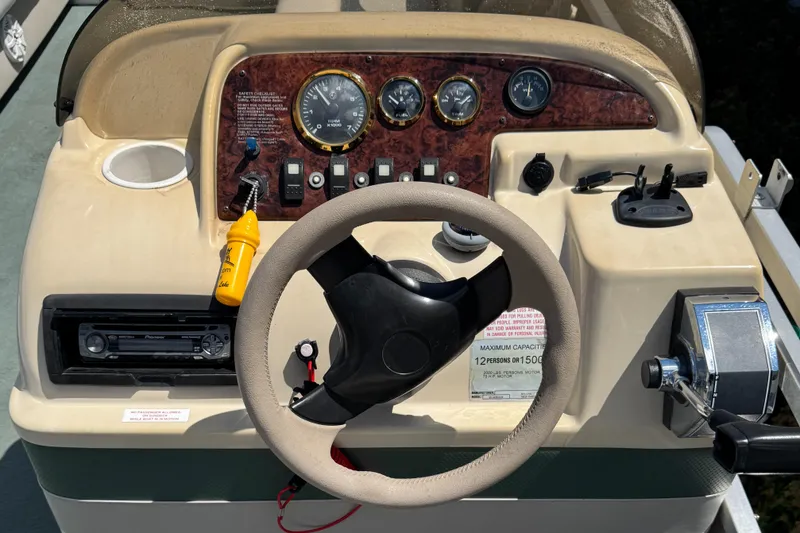 Slide: The Image of Steering console of a 2003 Sylvan 820 Mirage Cruise boat with gauges and controls. - 6