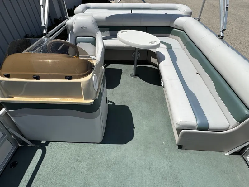 Slide: The Image of 2003 Sylvan 820 Mirage Cruise boat interior with seating and steering console. - 8