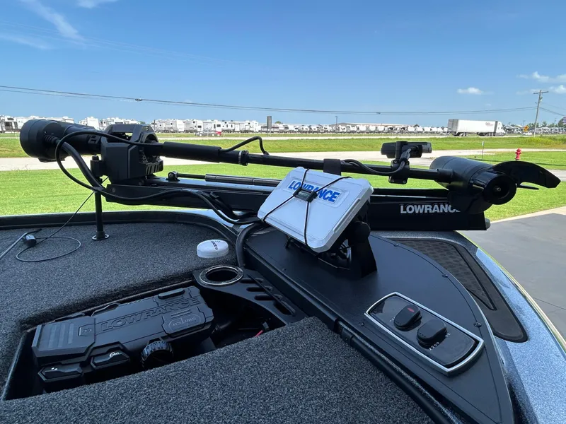 Slide: The Image of 2022 Nitro Z-18 boat with Lowrance electronics and trolling motor, parked outdoors. - 5