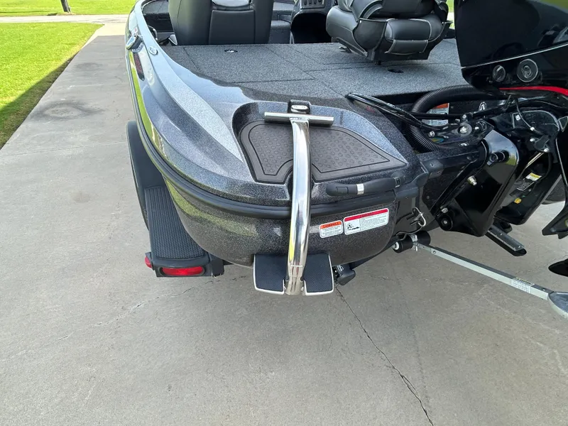 Slide: The Image of 2022 Nitro Z-18 boat rear view with ladder and motor on concrete surface. - 8