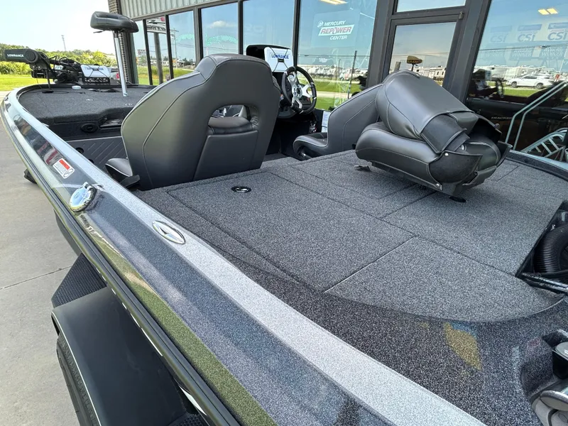 Slide: The Image of 2022 Nitro Z-18 boat interior with seating and steering wheel, displayed outdoors. - 9