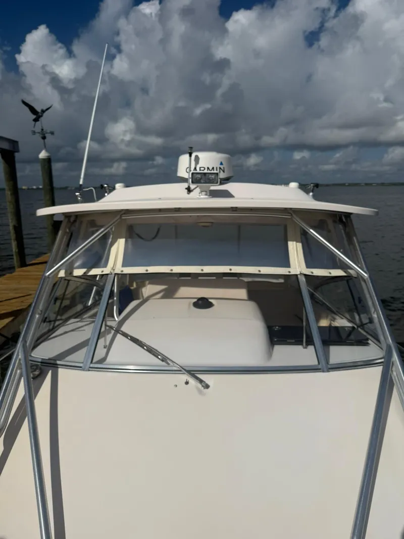 Slide: The Image of 2007 Grady-White Express 330 boat docked under cloudy sky. - 16