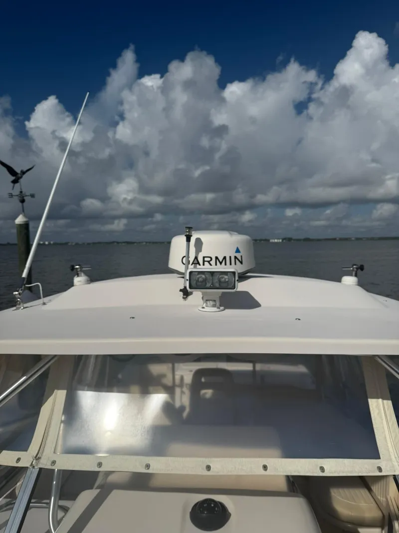 Slide: The Image of 2007 Grady-White Express 330 boat with Garmin equipment under a cloudy sky. - 17