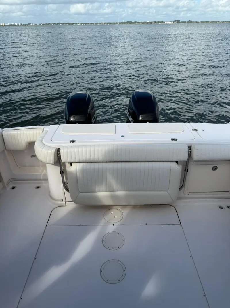 Slide: The Image of 2007 Grady-White Express 330 boat deck with twin outboard motors on calm water. - 22