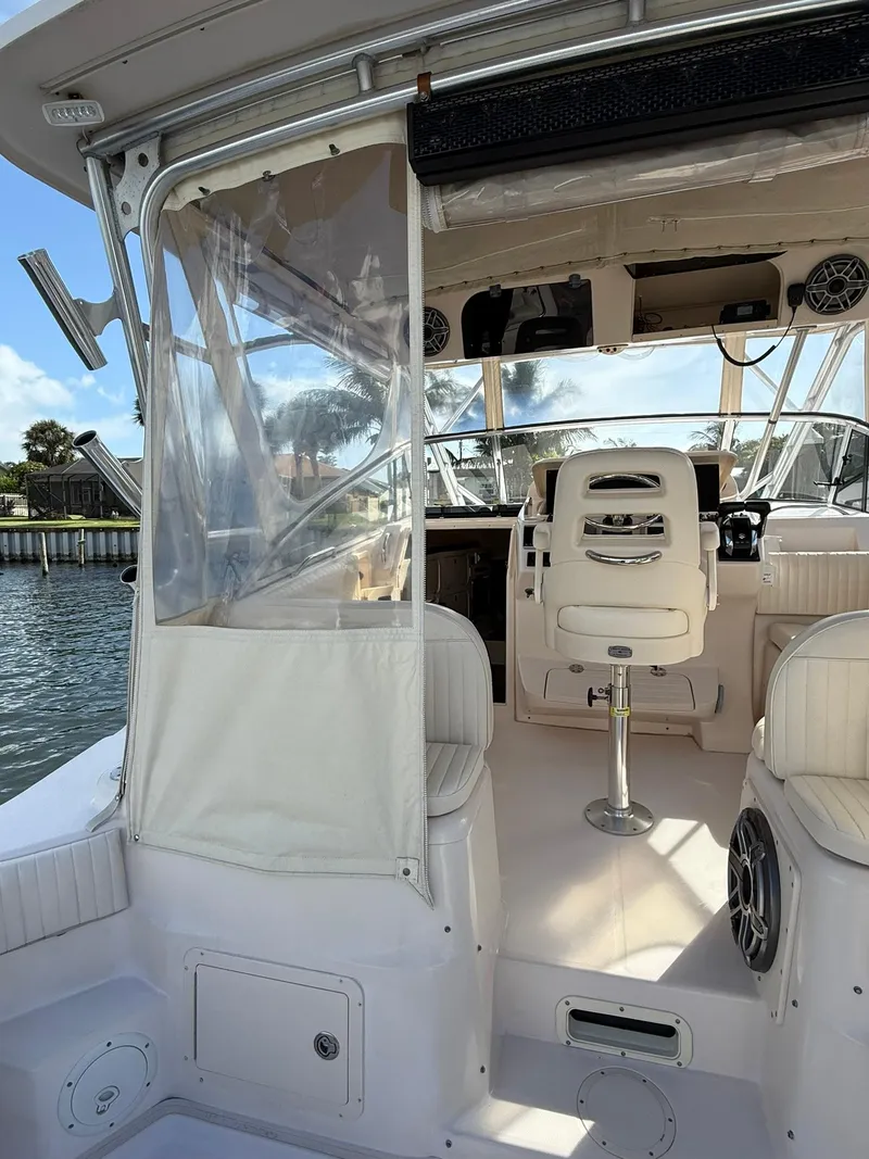 Slide: The Image of 2007 Grady-White Express 330 boat interior with helm seat and clear enclosure. - 26