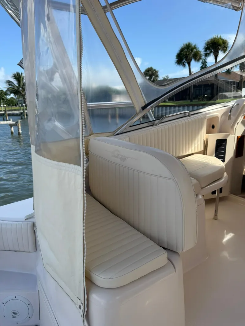 Slide: The Image of 2007 Grady-White Express 330 boat interior with white seating and clear canopy. - 29