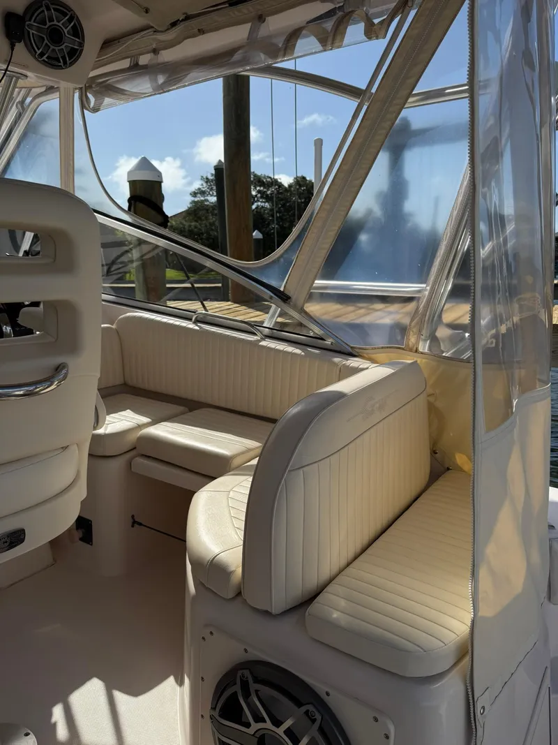 Slide: The Image of 2007 Grady-White Express 330 boat interior with cushioned seating and clear windows. - 33