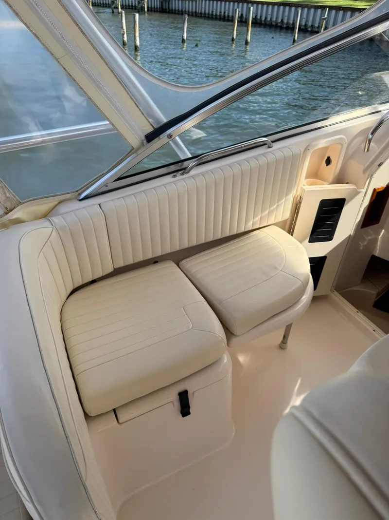 Slide: The Image of 2007 Grady-White Express 330 boat interior with cream seating by the water. - 36