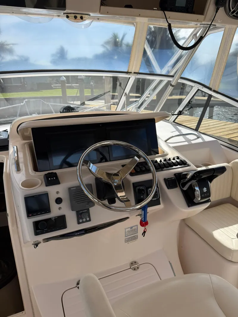 Slide: The Image of 2007 Grady-White Express 330 helm with steering wheel and control panel. - 37