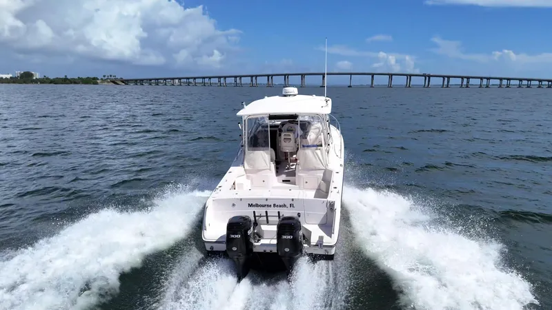 Slide: The Image of 2007 Grady-White Express 330 boat cruising near Melbourne Beach, FL, with bridge in background. - 4
