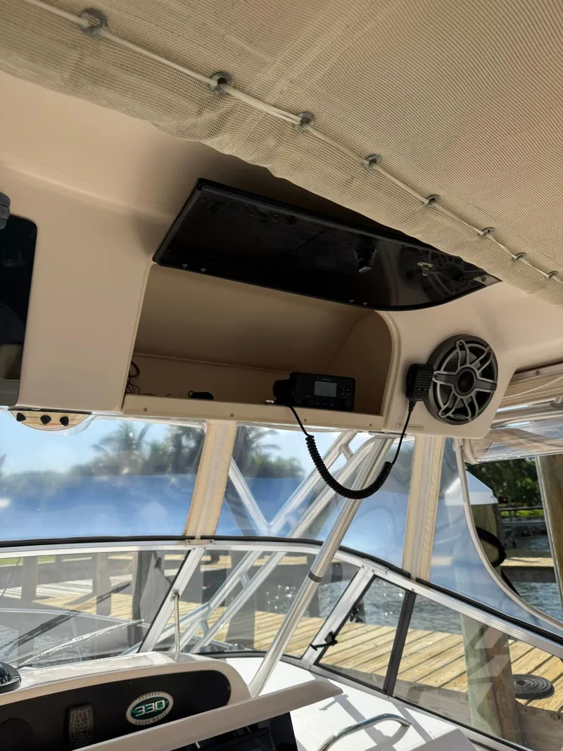 Slide: The Image of 2007 Grady-White Express 330 boat interior with speaker and radio equipment. - 40