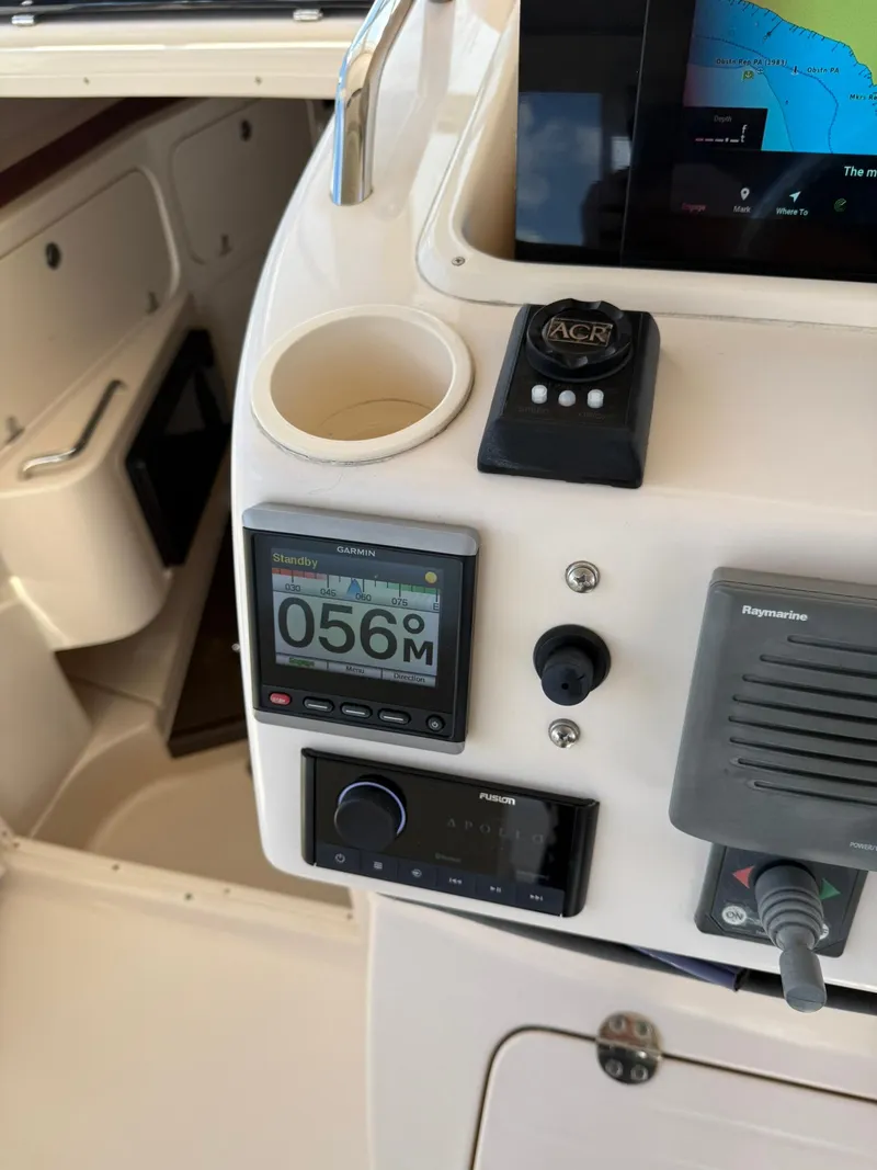 Slide: The Image of 2007 Grady-White Express 330 dashboard with Garmin and Raymarine electronics. - 44