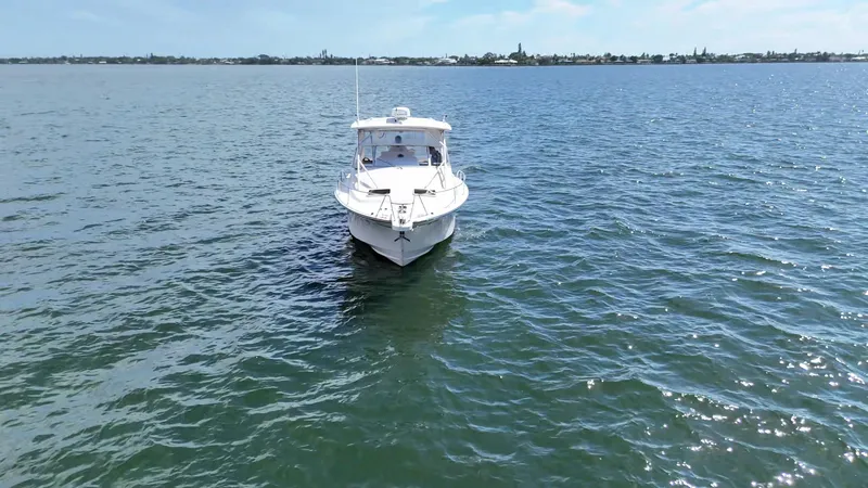 Slide: The Image of 2007 Grady-White Express 330 boat on open water, clear sky in background. - 8