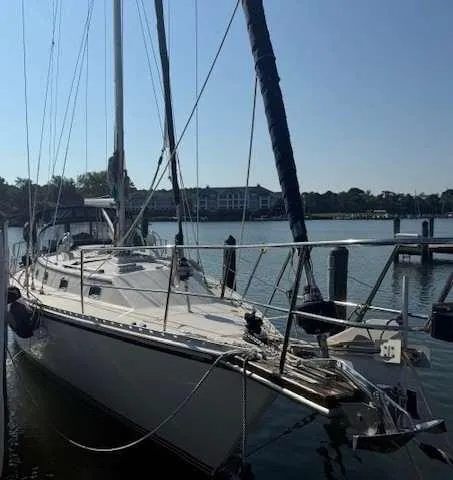 The Image of 2003 Caliber 40 LRC SE sailboat docked in a marina, clear sky background. - 0
